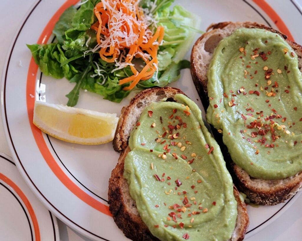 Avocado toast served with fresh salad