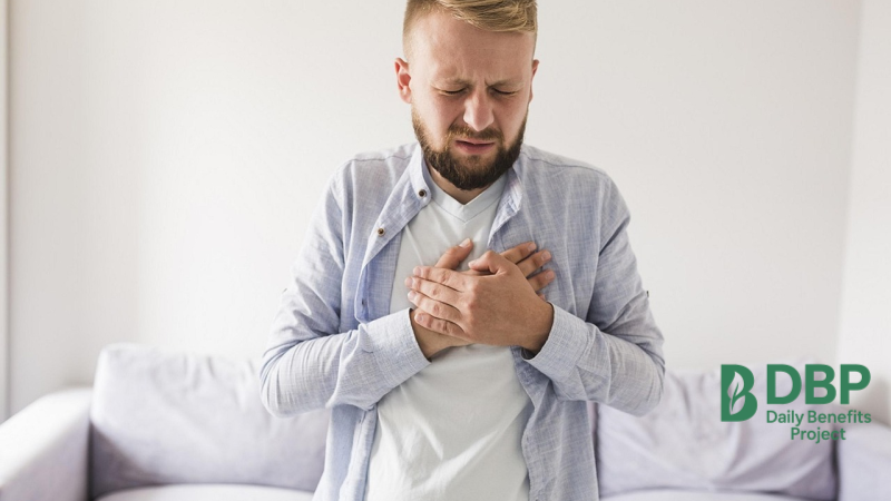 Heartburn and Side Effects from Lemon Water Man clutching his chest, appearing to have discomfort or heartburn