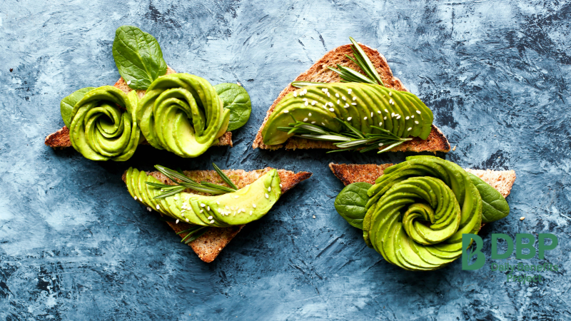 Avocado Toast with Herbs Sliced avocado beautifully arranged on toast with fresh herbs