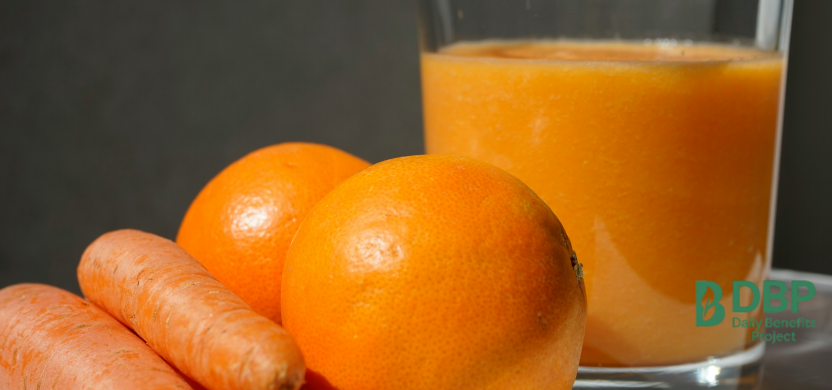 Carrot and Orange Juice with Whole Fruits Glass of carrot and orange juice with whole fruits