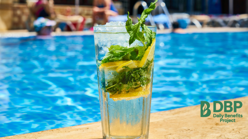 Glass of Lemon Water by the Pool A refreshing glass of lemon water with mint by a swimming pool