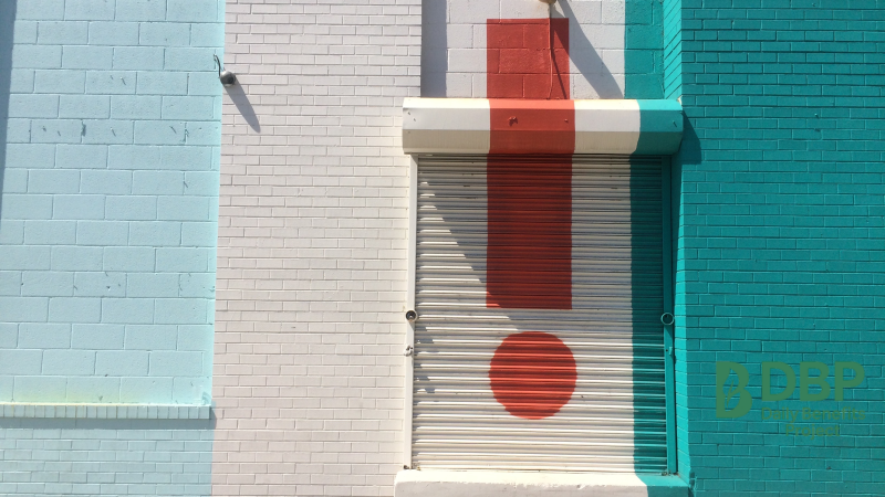 Exclamation Mark on Wall – Caution Symbol Large red exclamation mark painted on a building wall