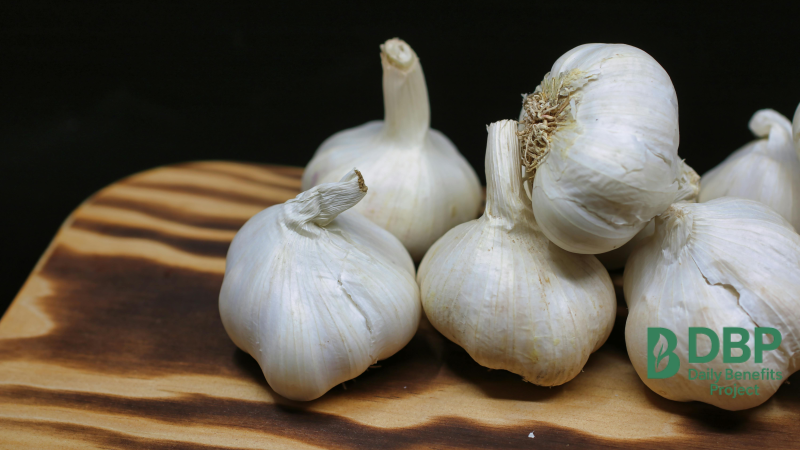 Fresh garlic bulbs on wooden board Raw garlic cloves known for natural immune boosting properties