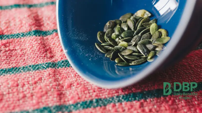 close-up of pumpkin seeds in a blue bowl rich in magnesium